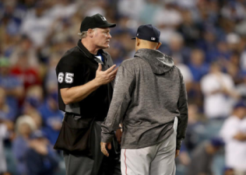 How much do major league umpires make per game and per season?